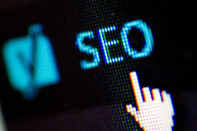 Image is of a digital hand pointing to the word SEO