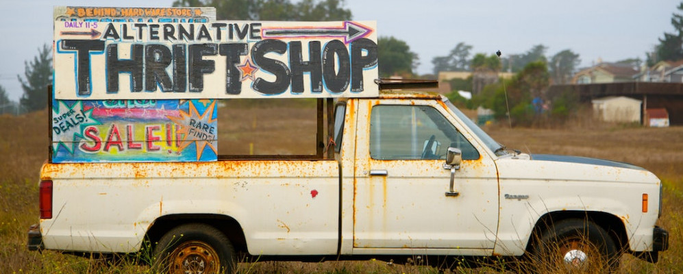 Image is of a truck with text that reads 'alternative thrift shop/sale'