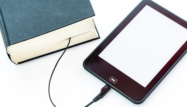 Image is of a tablet connected to a book as if to look like an E-Book